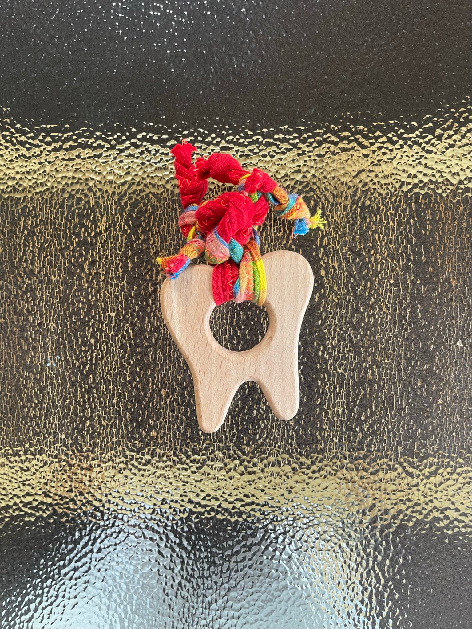 teething toy with plaited fabric fiddley bits