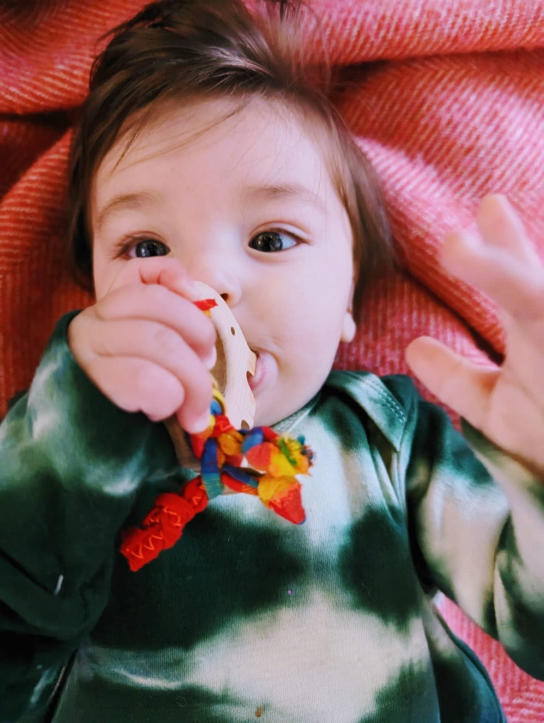 teething toy with plaited fabric fiddley bits