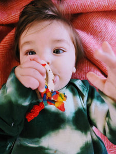 teething toy with plaited fabric fiddley bits