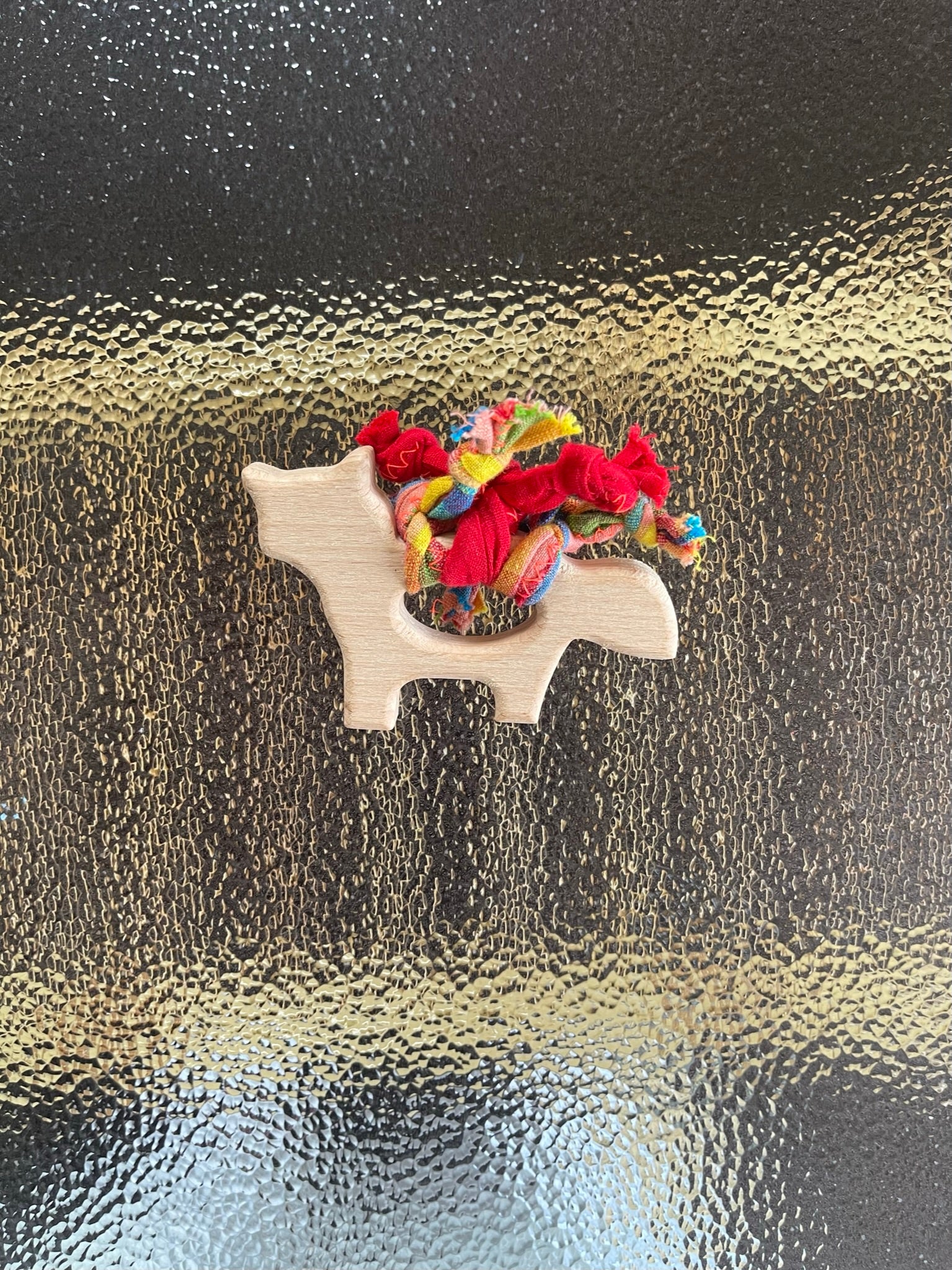 teething toy with plaited fabric fiddley bits