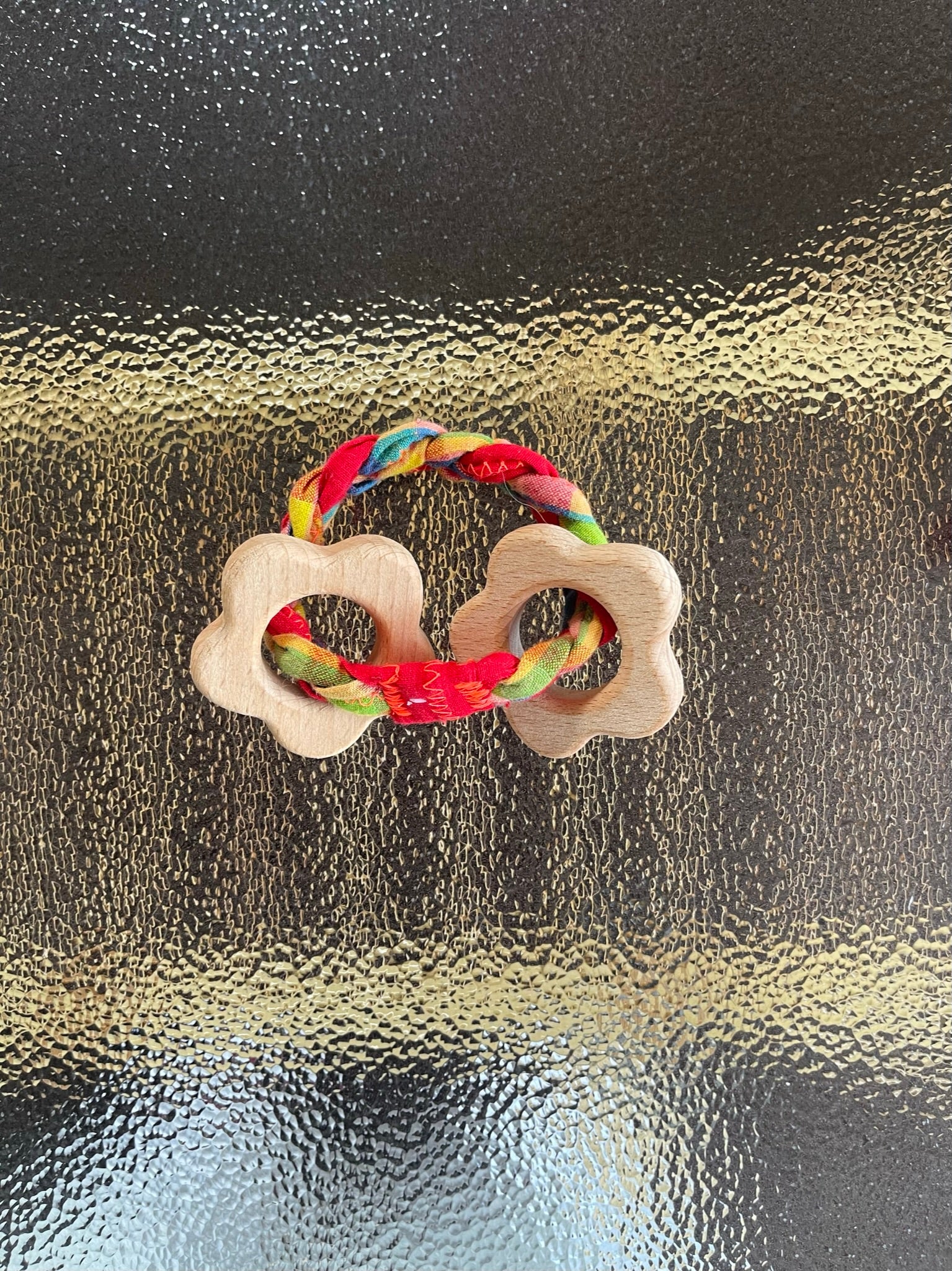 teething toy with plaited fabric fiddley bits