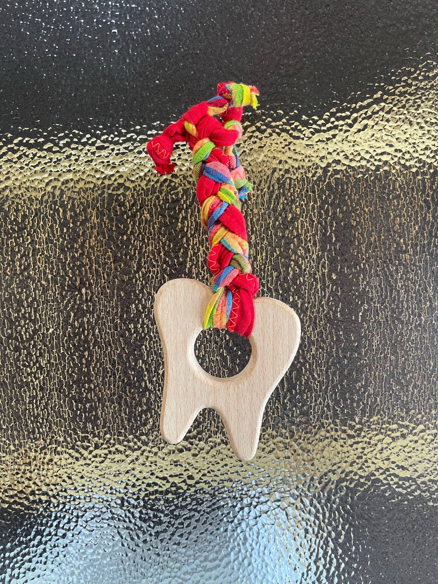 teething toy with plaited fabric fiddley bits